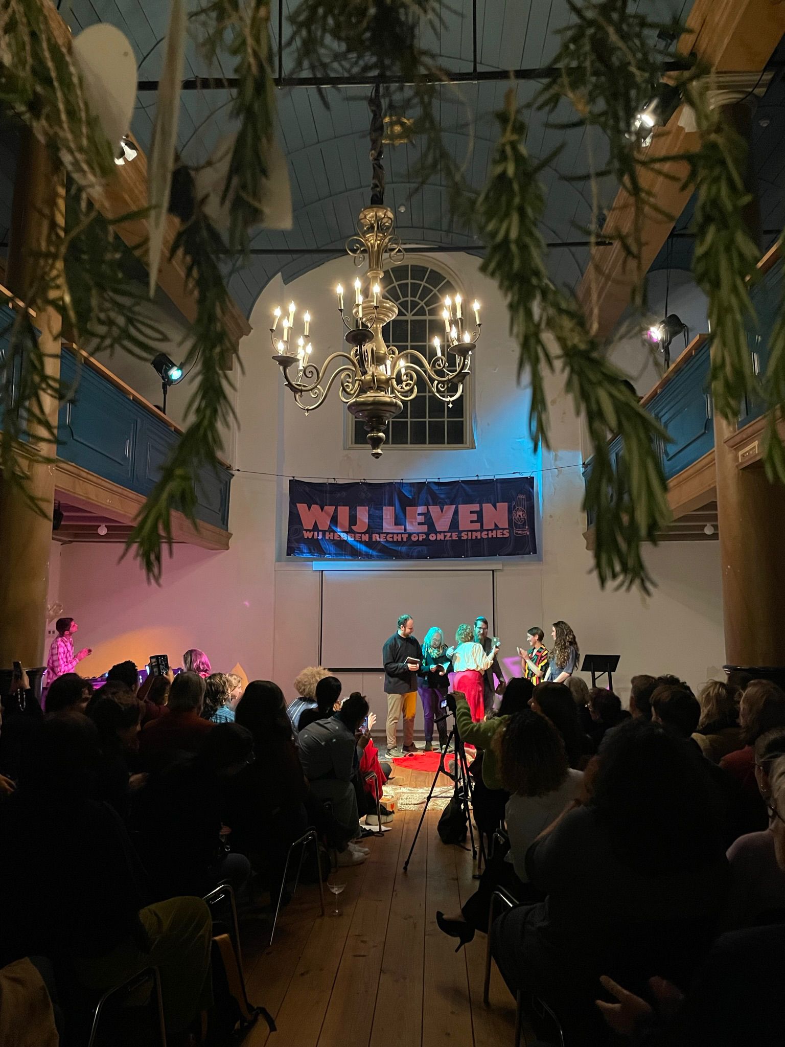 Wij Leven banner - with rosemary hanging in the foreground. Taken by Lilit Zeltsburg